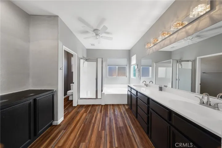 Luxurious Primary Bathroom With Dual Vanities, Soaking Tub, And Walk-In Shower