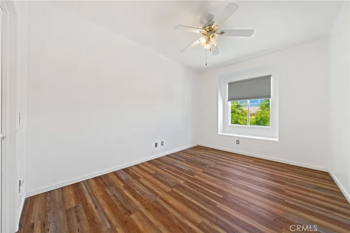 Bright And Spacious Secondary Bedroom With Ceiling Fan And Large Window