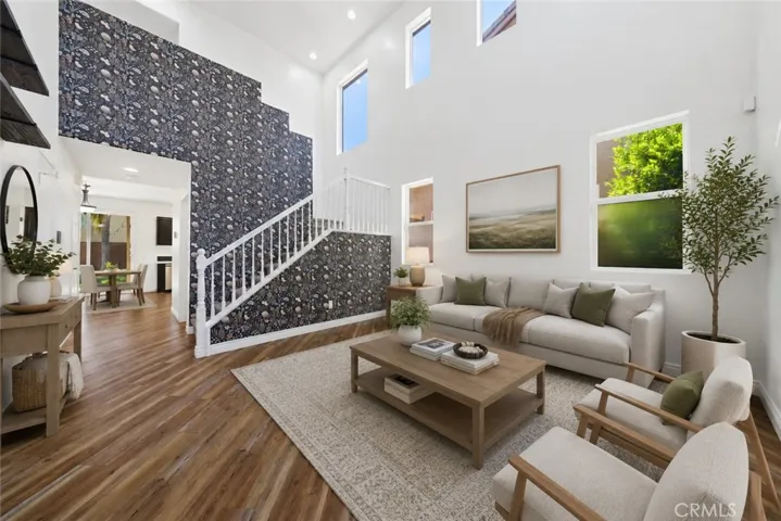 Spacious Open-Concept Living Area With Dramatic Two-Story Ceilings - Digitally Staged