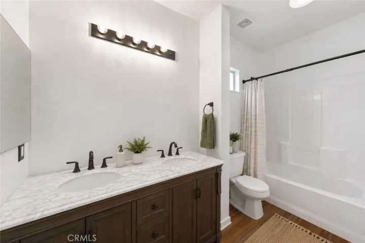 Upstairs Full Bathroom Featuring Dual Vanities And Tub/Shower Combination - Digitally Staged