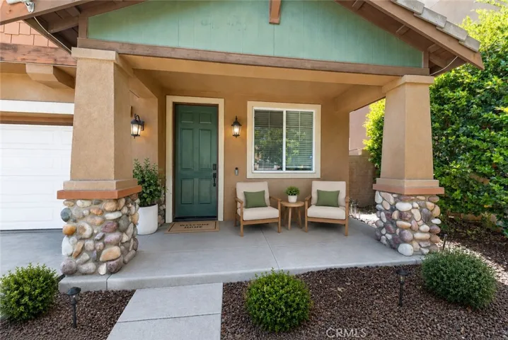 Welcoming Covered Front Porch With Stone Accents - Digitally Staged