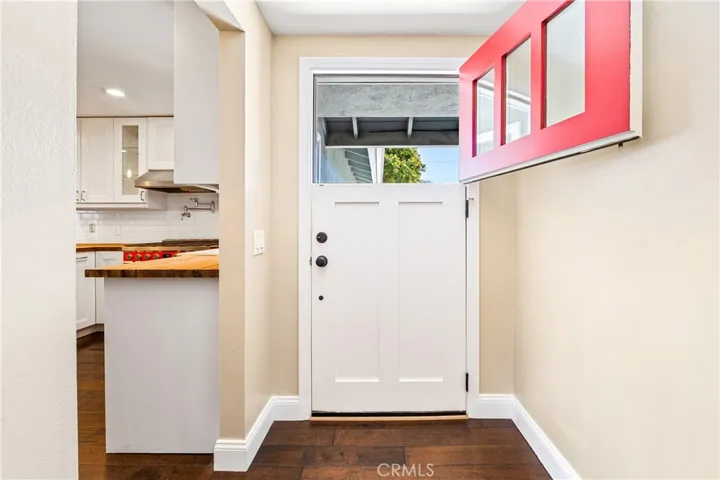 Custom Dutch front door welcomes you into this warm and charming coastal home.