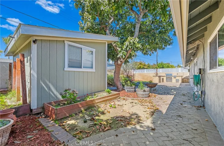 Charming backyard studio overlooking a peaceful pond beneath a mature avocado tree perfect as a home office, gym, creative space, or private retreat.