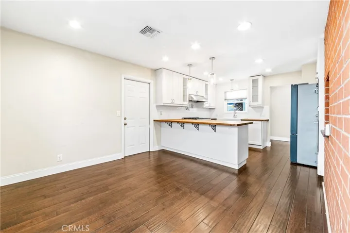 Open-concept living and dining areas flow seamlessly into the beautifully remodeled gourmet kitchen.