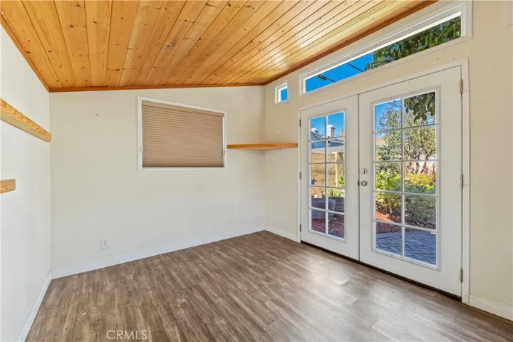 Charming backyard studio overlooking a peaceful pond beneath a mature avocado tree perfect as a home office, gym, creative space, or private retreat.