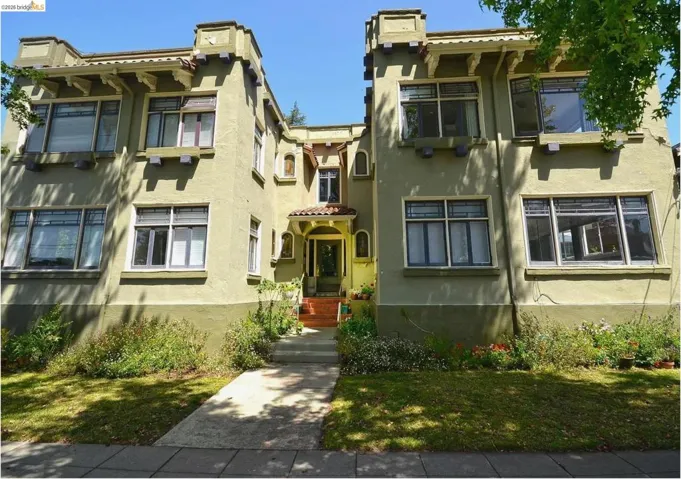 Stucco exterior with architectural corbels and a recessed entry