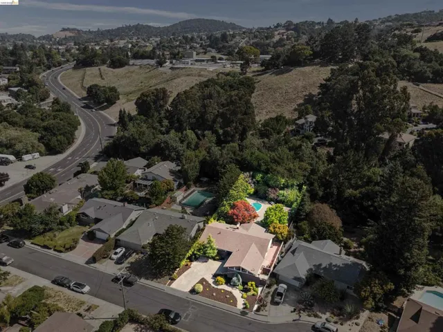 Aerial perspective highlighting a single-story residence with a light-colored roof