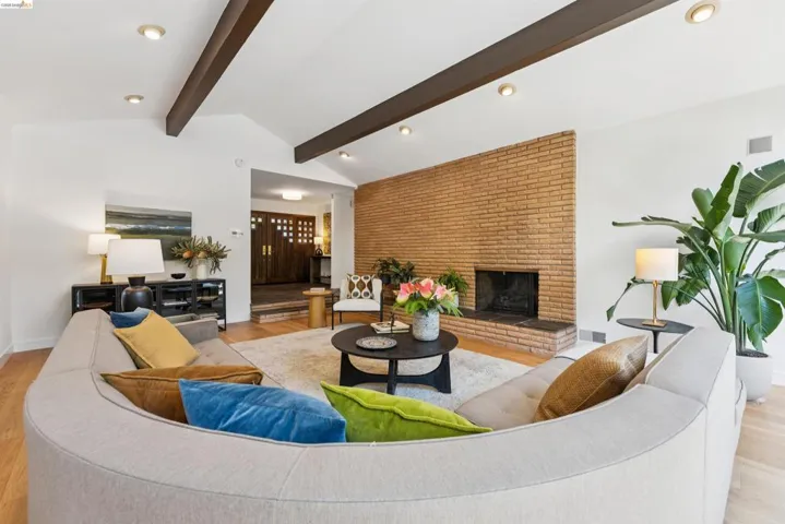 Vaulted ceiling with exposed wood beams and recessed lighting