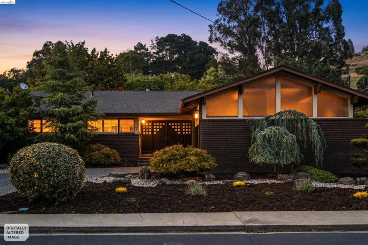 Mid-century modern exterior featuring dark brick siding and a low-pitched roofline