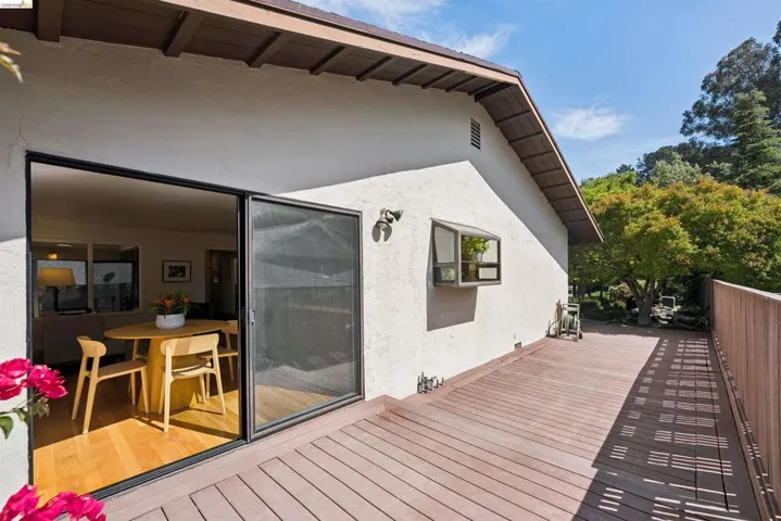 Expansive outdoor deck featuring wood-finish flooring and a wood railing