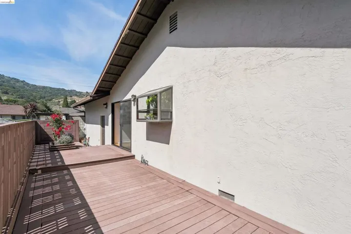Multi-level deck featuring wood-finish decking and wood privacy fencing