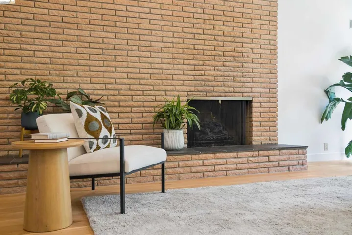 Brick fireplace with a black metal screen and a stone hearth