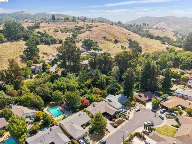 Aerial perspective showcasing a residential neighborhood with surrounding hills