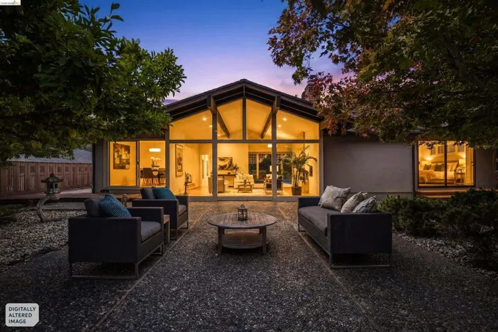 Exterior featuring a dramatic A-frame design with expansive floor-to-ceiling windows, modern stucco siding, and a durable composite roof