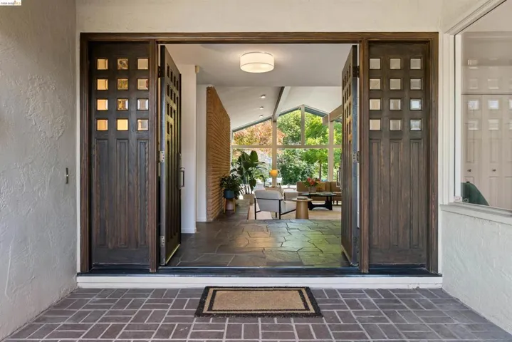 Wide-open double entry doors with square window inserts