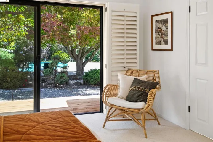 Sliding glass door opening to an exterior wood-finish deck