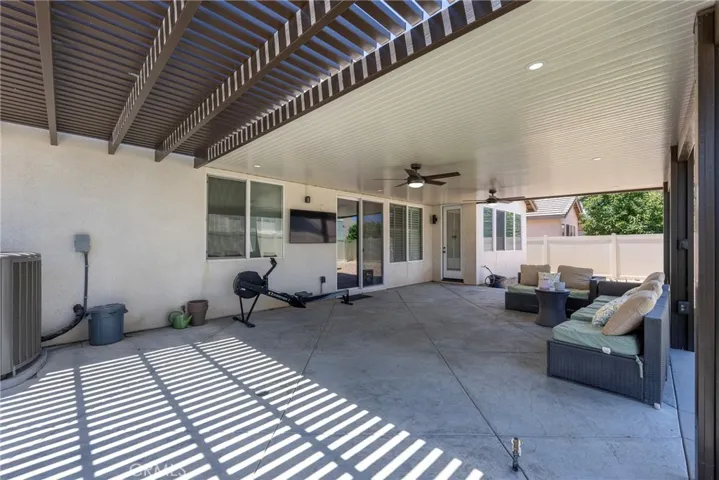 Covered patio includes large solid aluminum cover and a smaller slatted aluminum section
