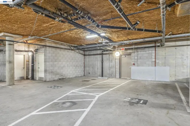 To the left of parking spaces is a storage closet where independent storage unit to #211 is housed.