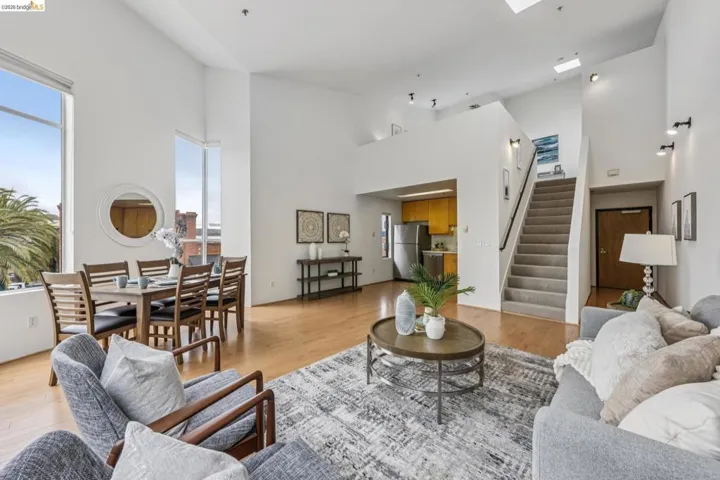 Open-concept living space with high ceilings and wood-finish flooring