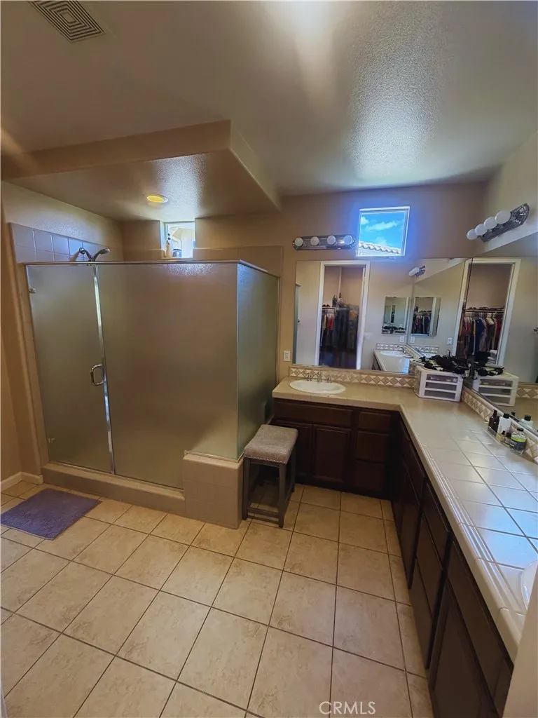 Primary Bath - Image digitally enhanced with AI to remove the seller's personal items for privacy.