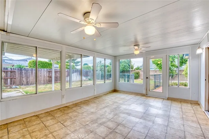 The enclosed sunroom offers exceptional flexibility and can easily serve as a home office, hobby room, fitness area, playroom, or peaceful retreat.