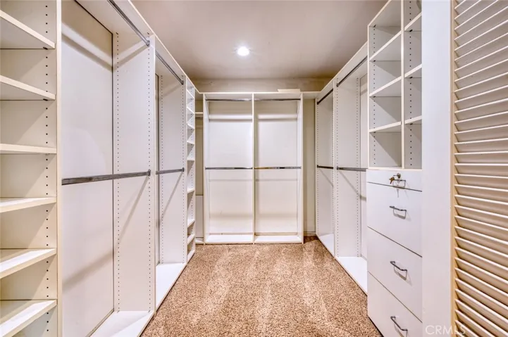 Primary suite oversized custom walk-in closet.