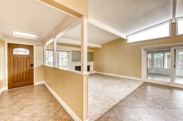 Step inside to a warm and inviting living room centered around a cozy fireplace that flows effortlessly into the formal dining area, and easy access to the versatile sun room, creating an ideal setting for both entertaining and everyday living.