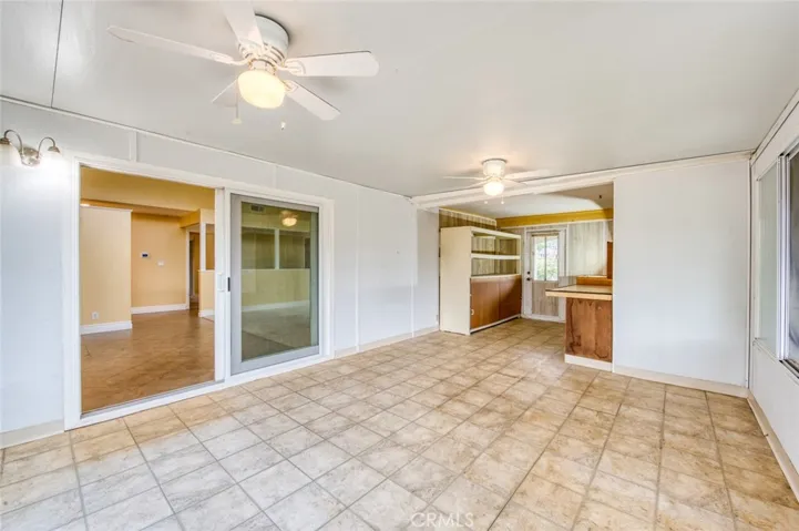The enclosed sunroom offers exceptional flexibility and can easily serve as a home office, hobby room, fitness area, playroom, or peaceful retreat.