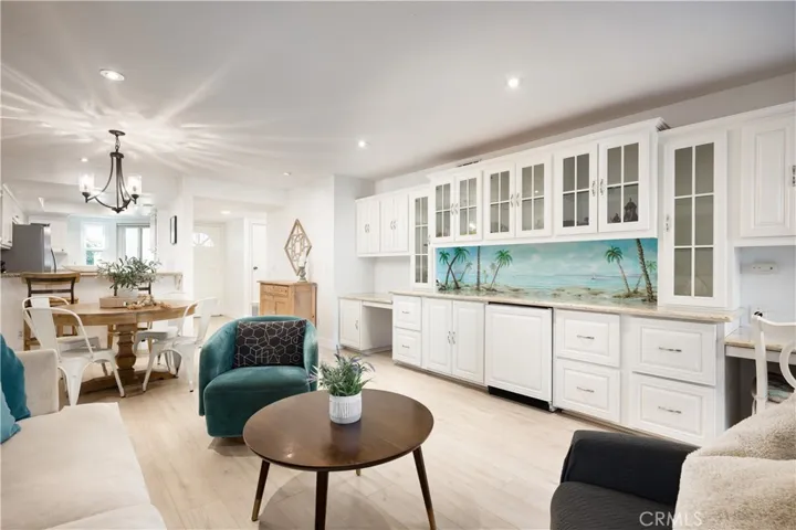 Custom Built Ins in Light Bright & Airy Living Room add ample storage, Beverage Fridge & Built in Desks - Or Remove for More Living Space