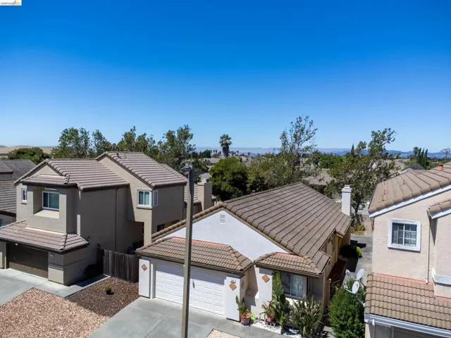 Residential properties featuring stucco exteriors and tile roofs