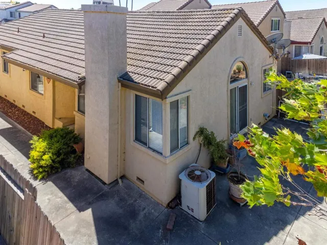 Stucco exterior with a tiled roof and prominent chimney