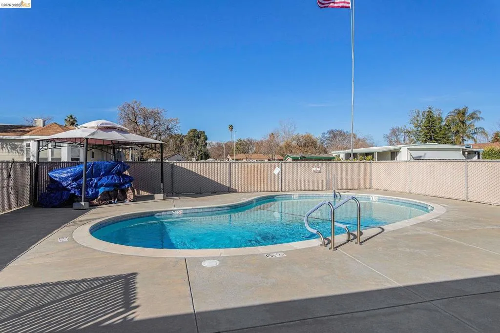 Community pool featuring a patio area Community pool featuring a patio area