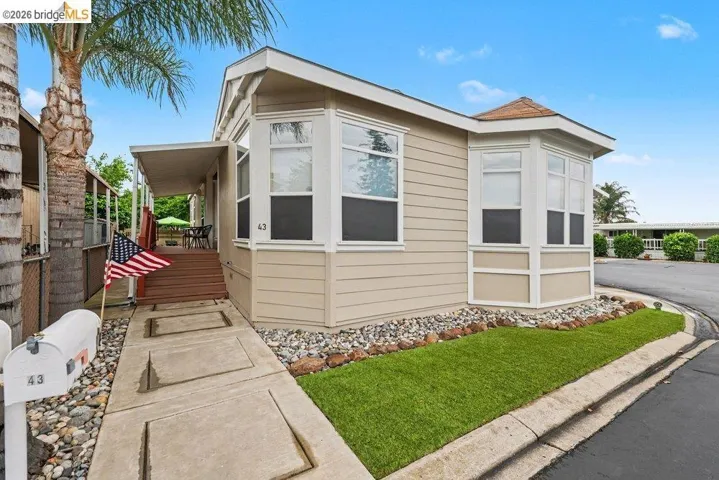 View of property exterior with a wooden deck
