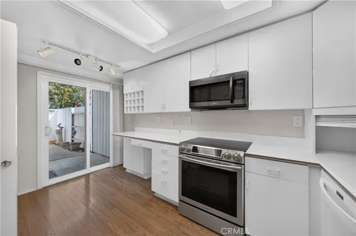 Sliding door in the kitchen opens to the fully enclosed front walkway.