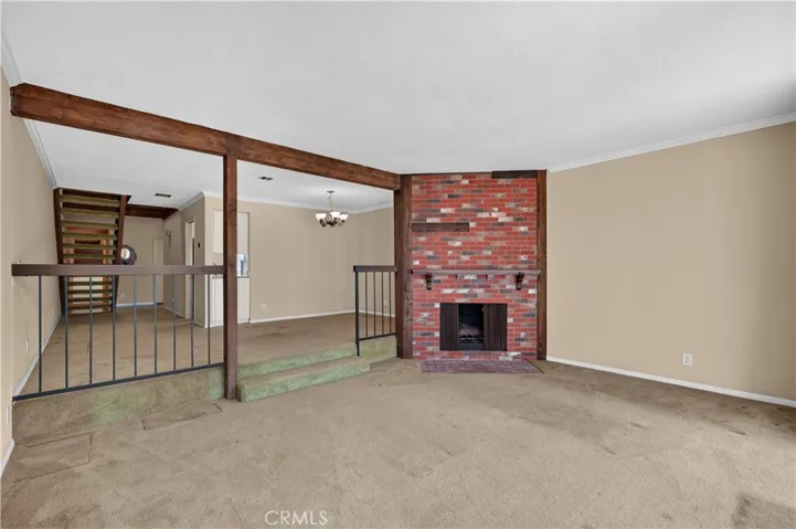 Living room with traditional brick fireplace.