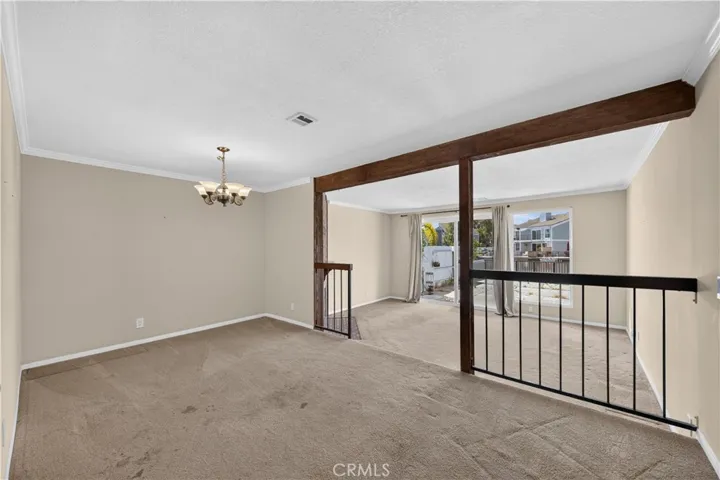 Open concept dining and living rooms with view of the water.