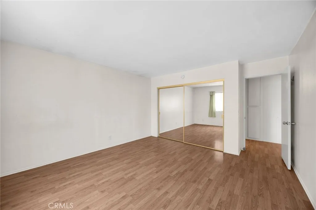 Another view of 1st bedroom with mirrored closet doors