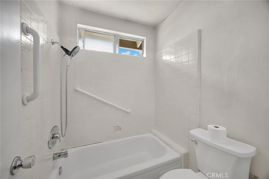 Main bathroom - private toilet, shower & tub area