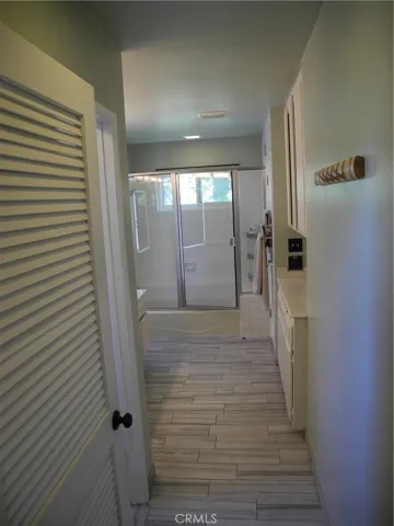 Master bathroom with door and cabinets on right side