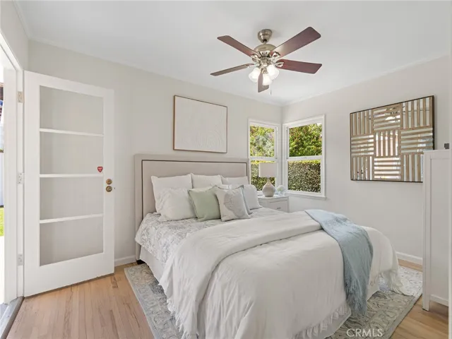 Primary bedroom with door that leads onto patio and backyard.