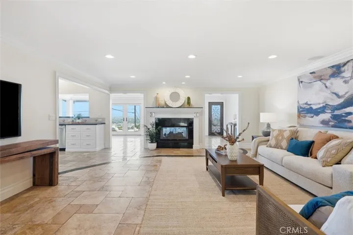 Family room fireplace open to kitchen, bonus room, living and dining rooms also with views