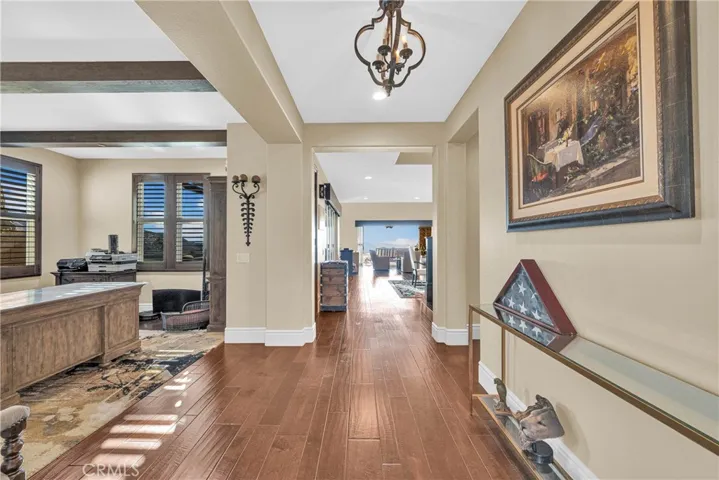 Iron-scrolled entry door and wide-plank flooring