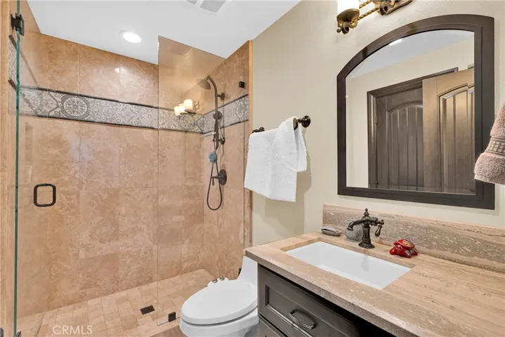 Main-level bath in custom tile and iron detail
