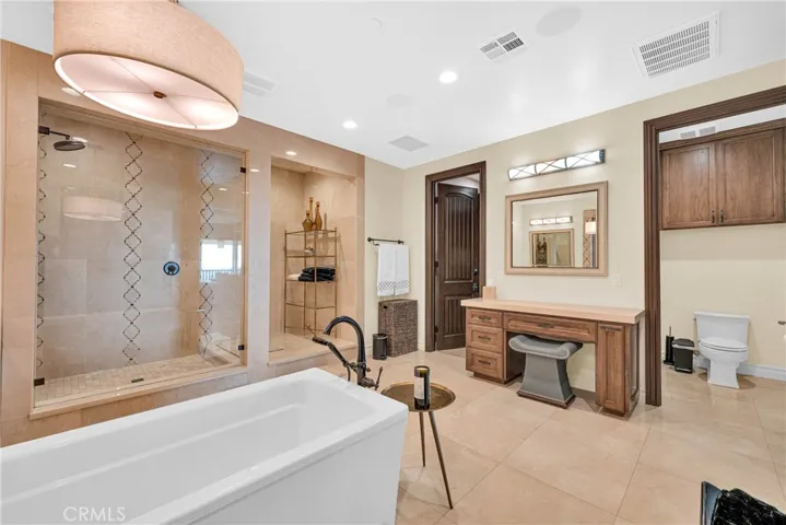 Freestanding soaking tub in a marble-finished room