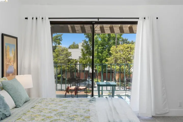 Sliding glass doors opening to a private balcony with a metal railing