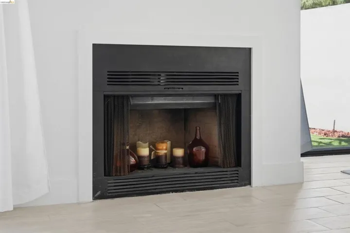 Built-in fireplace with a black metal frame and white surround
