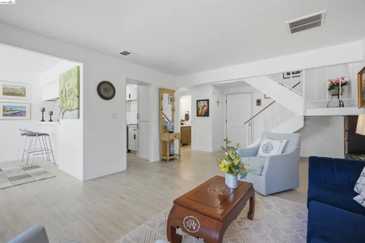 Bright living area featuring light wood-finish flooring and white walls