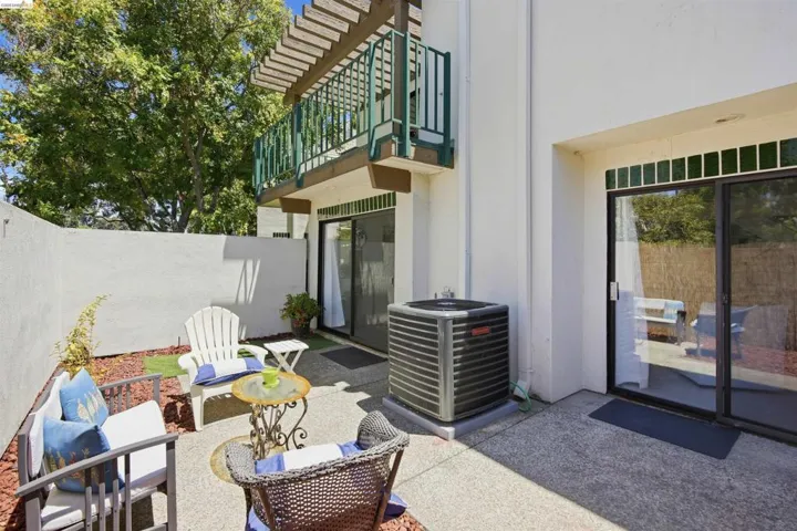 Private patio space featuring a concrete slab and a walled perimeter