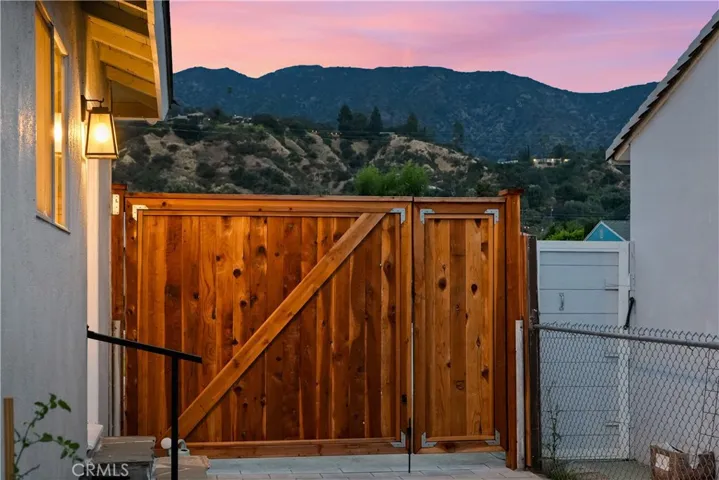 Custom vehicle-and-pedestrian gates with views of the foothills