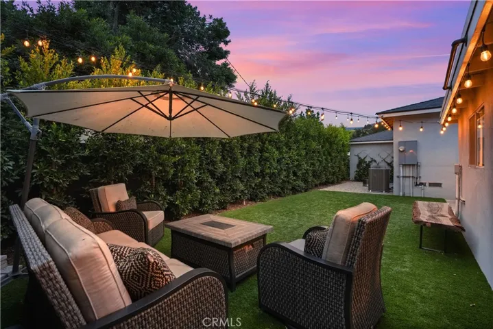 Backyard retreat with tall privacy ficus edges